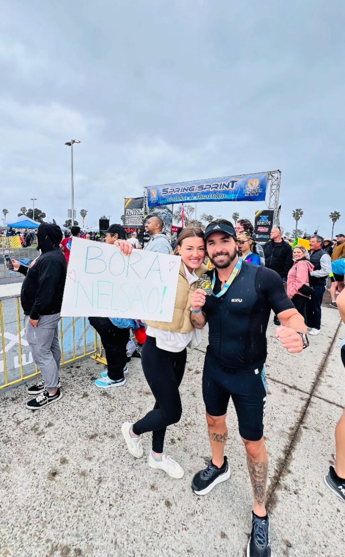 Nelson and his girlfriend at a triathlon finish line