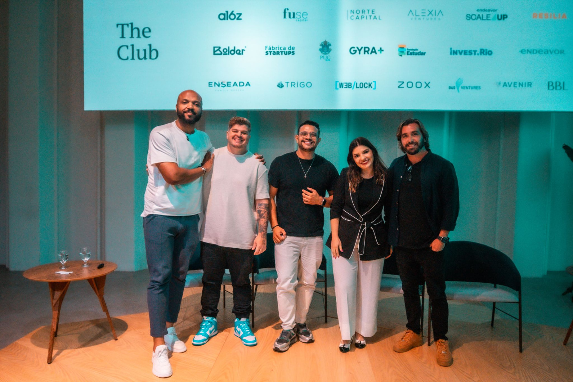 Nelson with speakers and hosts at a community event at The Club