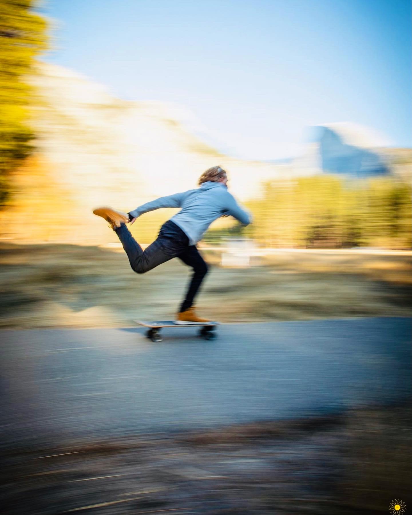 Nelson skateboarding along a road in Yosemite valley